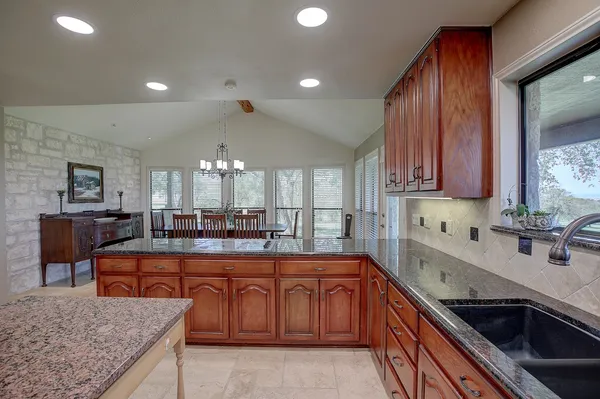a kitchen with sink cabinets and stainless steel appliances