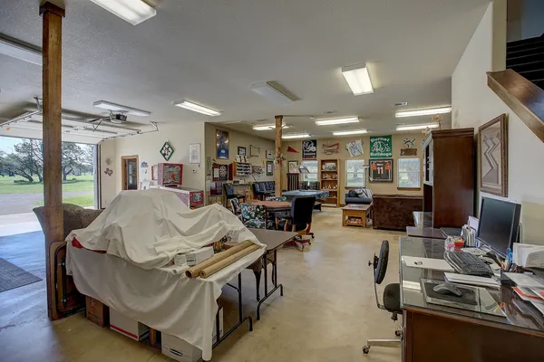 a living room with furniture a flat screen tv and kitchen view