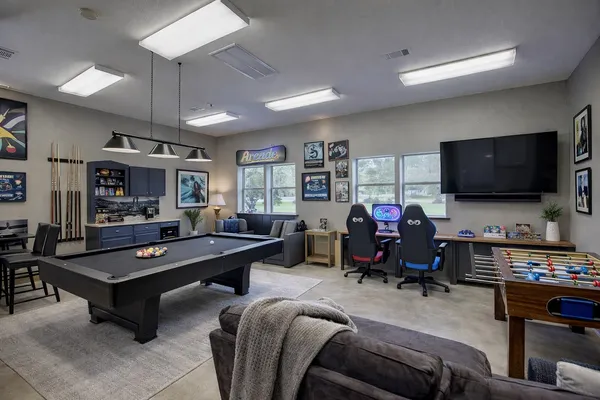 a living room with furniture a ceiling fan and a rug