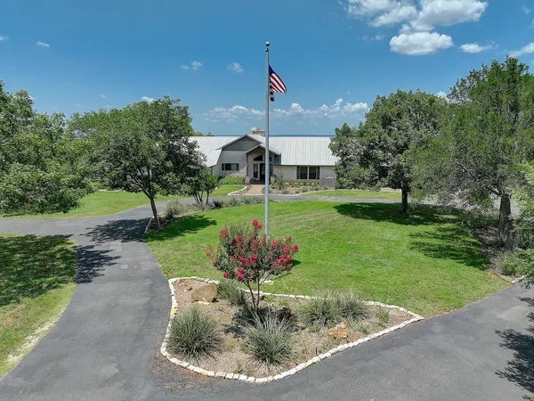 a view of a garden with plants and a fountain