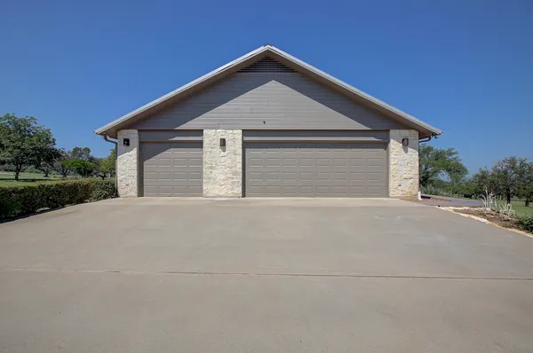 a view of a house with a big yard and large trees