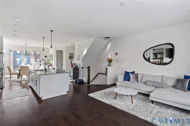 a living room with furniture and a wooden floor