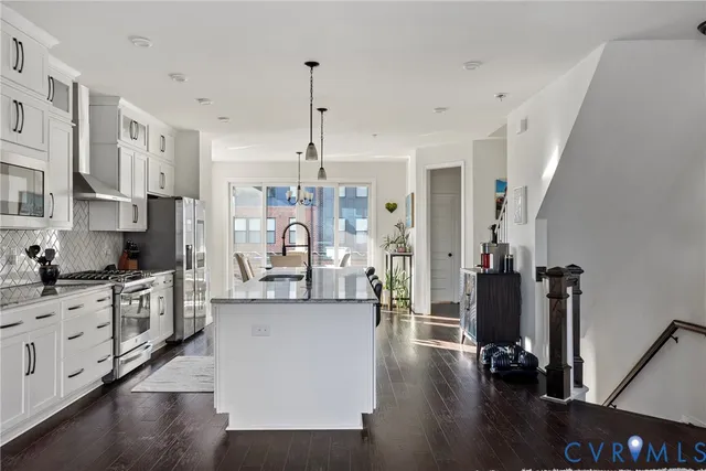 a large kitchen with cabinets and wooden floor