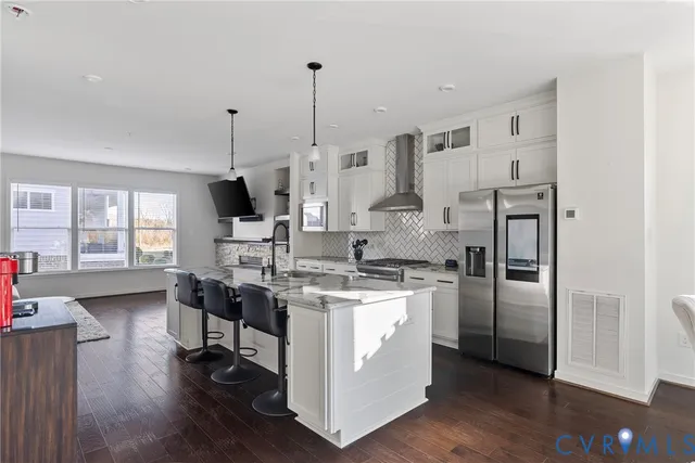 a kitchen with stainless steel appliances granite countertop a stove and a refrigerator