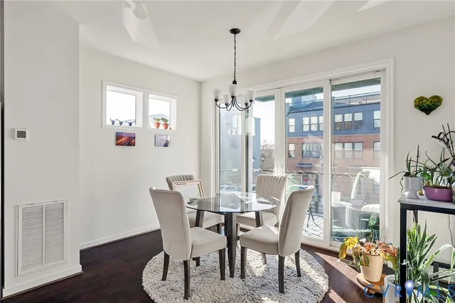 a dining room with furniture a chandelier and wooden floor