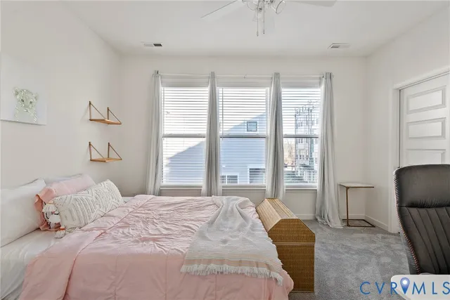 a bedroom with a chair and a chair