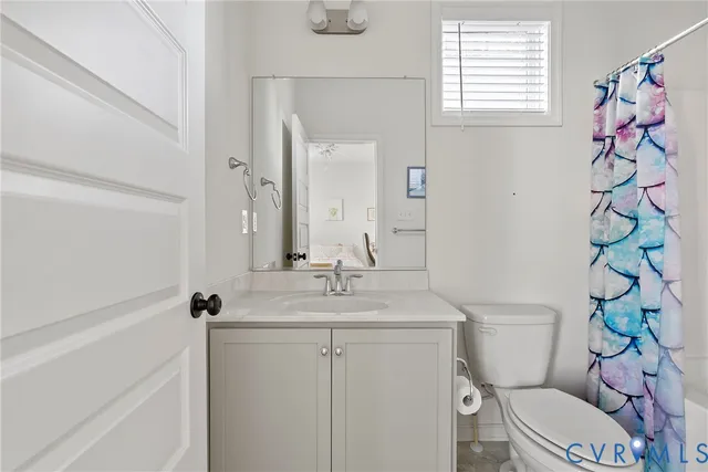 a bedroom with a bed lamp and a large window