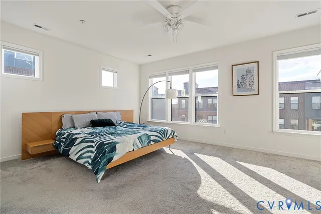 a bedroom with a bed and a painting on the wall