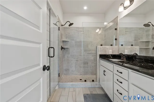 a kitchen with granite countertop a sink stove and cabinets