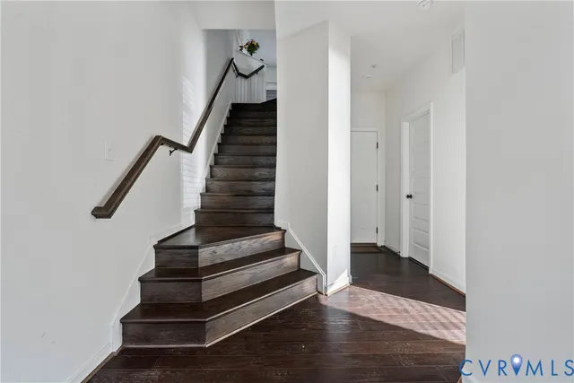 a view of entryway and hall with wooden floor