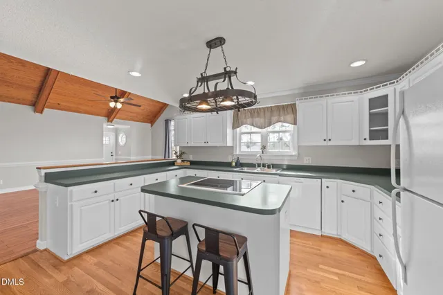 a kitchen with a sink cabinets and window