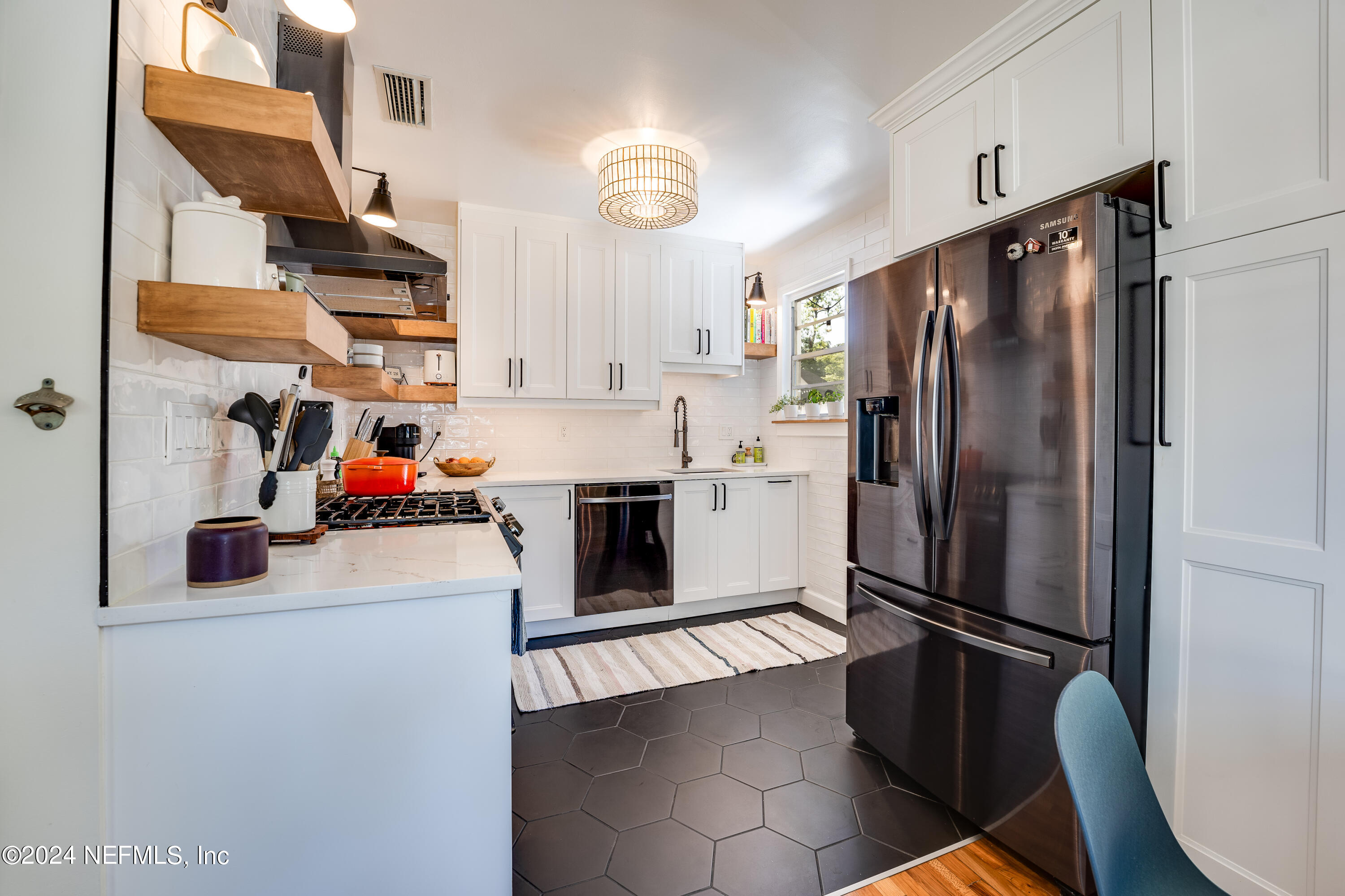 1322 Rensselaer Avenue Jacksonville, FL 32205 - Photo 13 of 37 a kitchen with stainless steel appliances granite countertop a refrigerator sink and stove