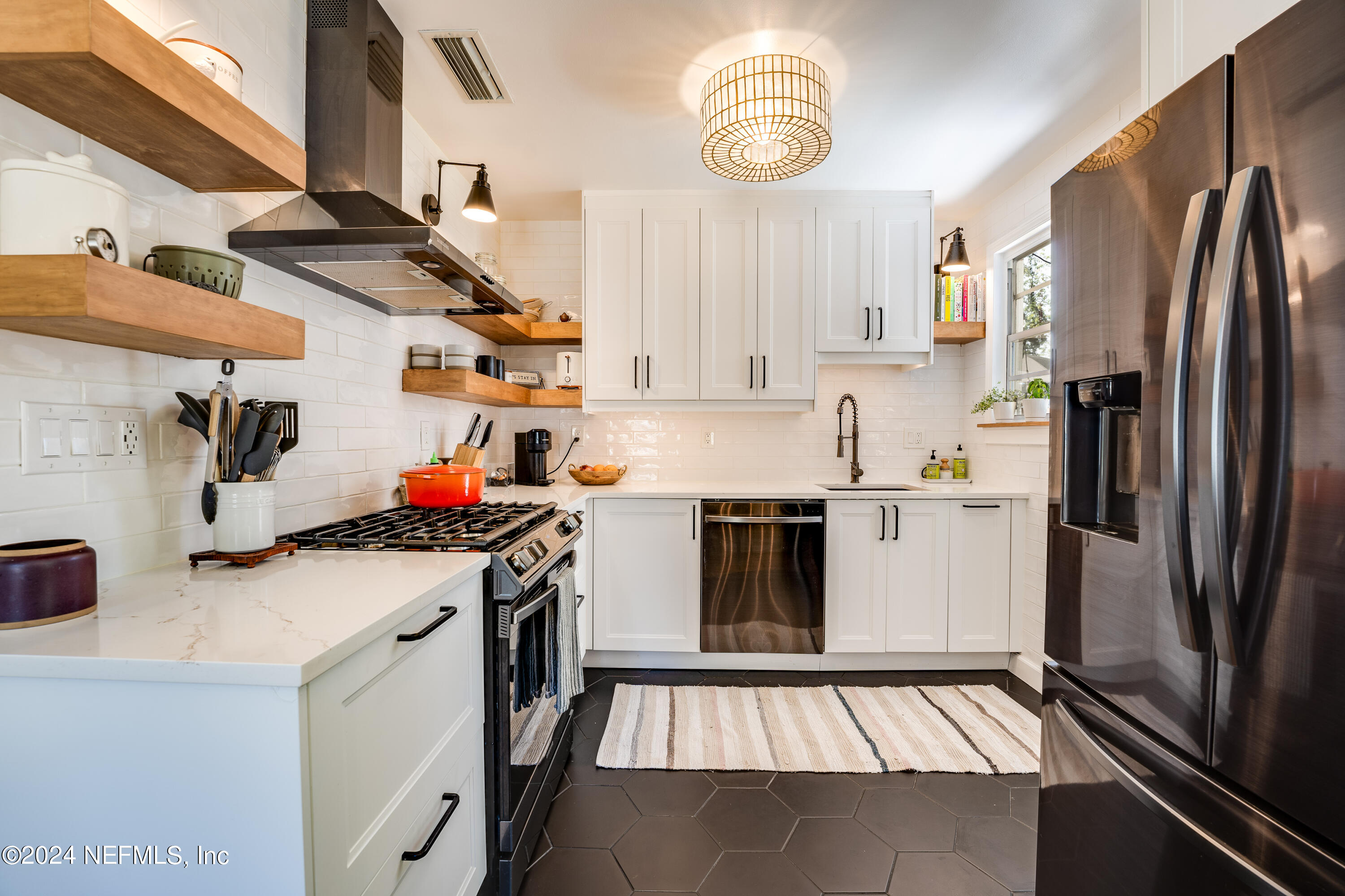 1322 Rensselaer Avenue Jacksonville, FL 32205 - Photo 14 of 37 a kitchen with stainless steel appliances a stove a sink and a refrigerator