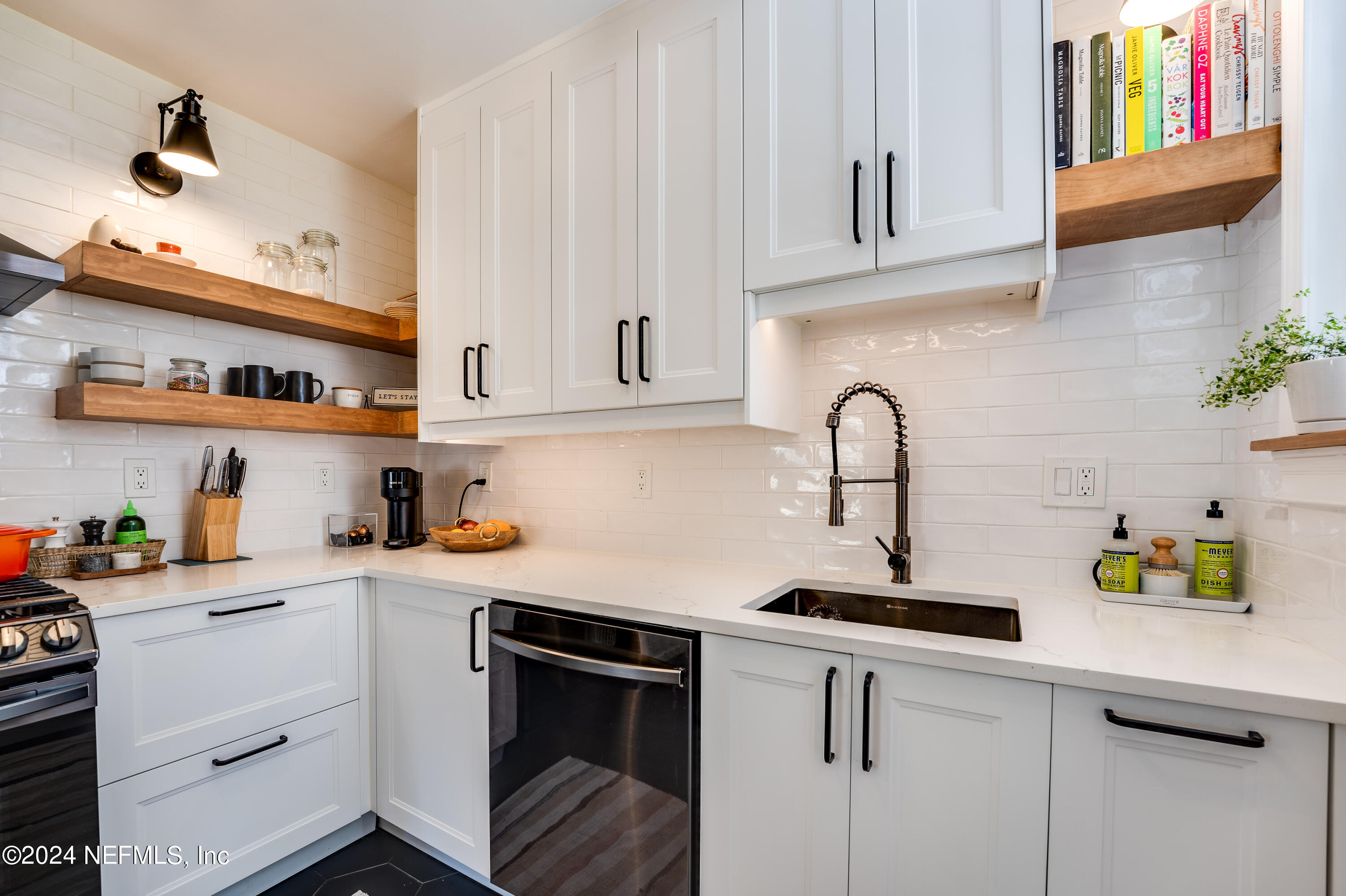 1322 Rensselaer Avenue Jacksonville, FL 32205 - Photo 16 of 37 a kitchen with stainless steel appliances granite countertop a sink dishwasher and cabinets with wooden floor