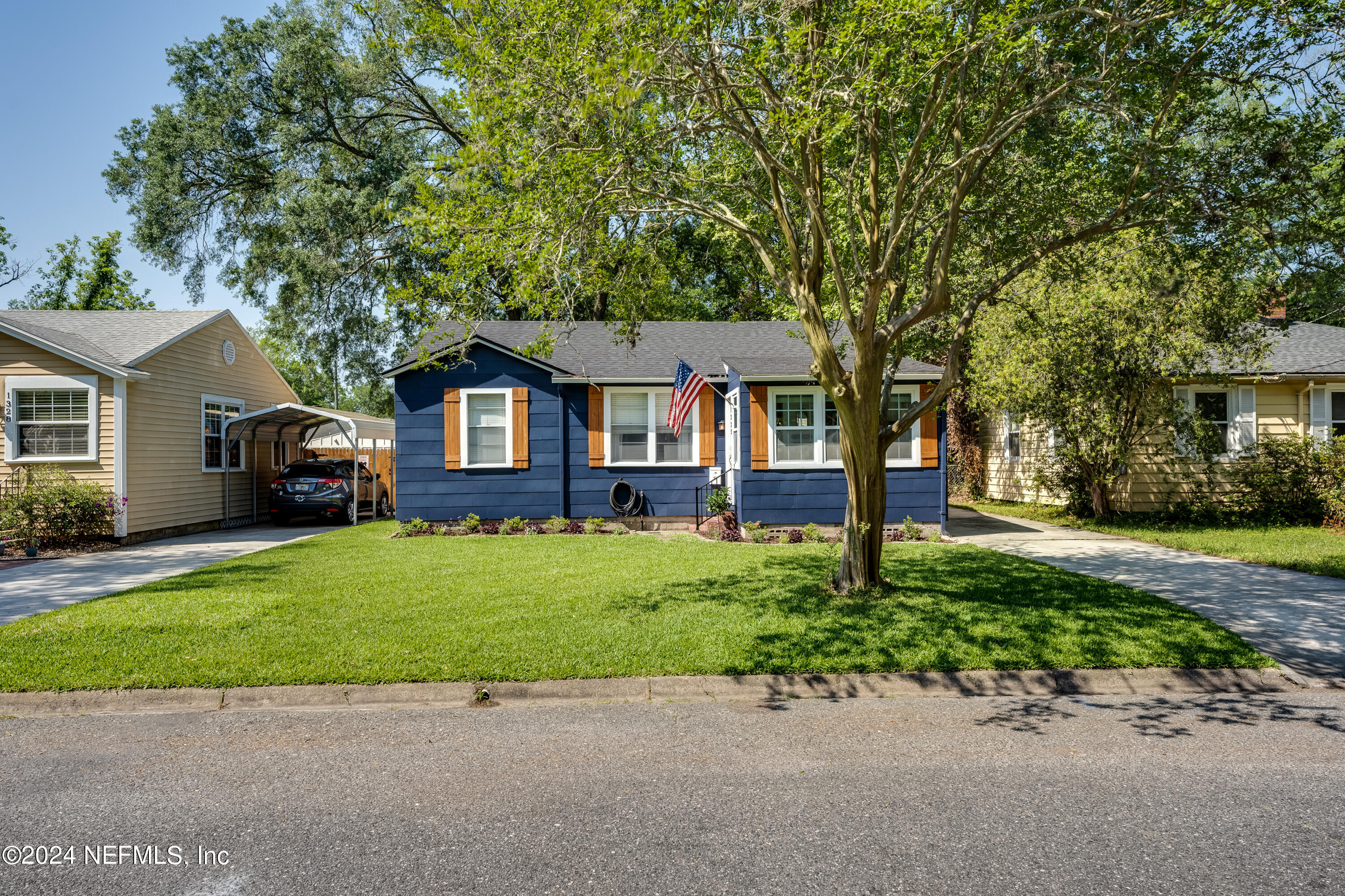 1322 Rensselaer Avenue Jacksonville, FL 32205 - Photo 2 of 37 a front view of a house with a garden and trees