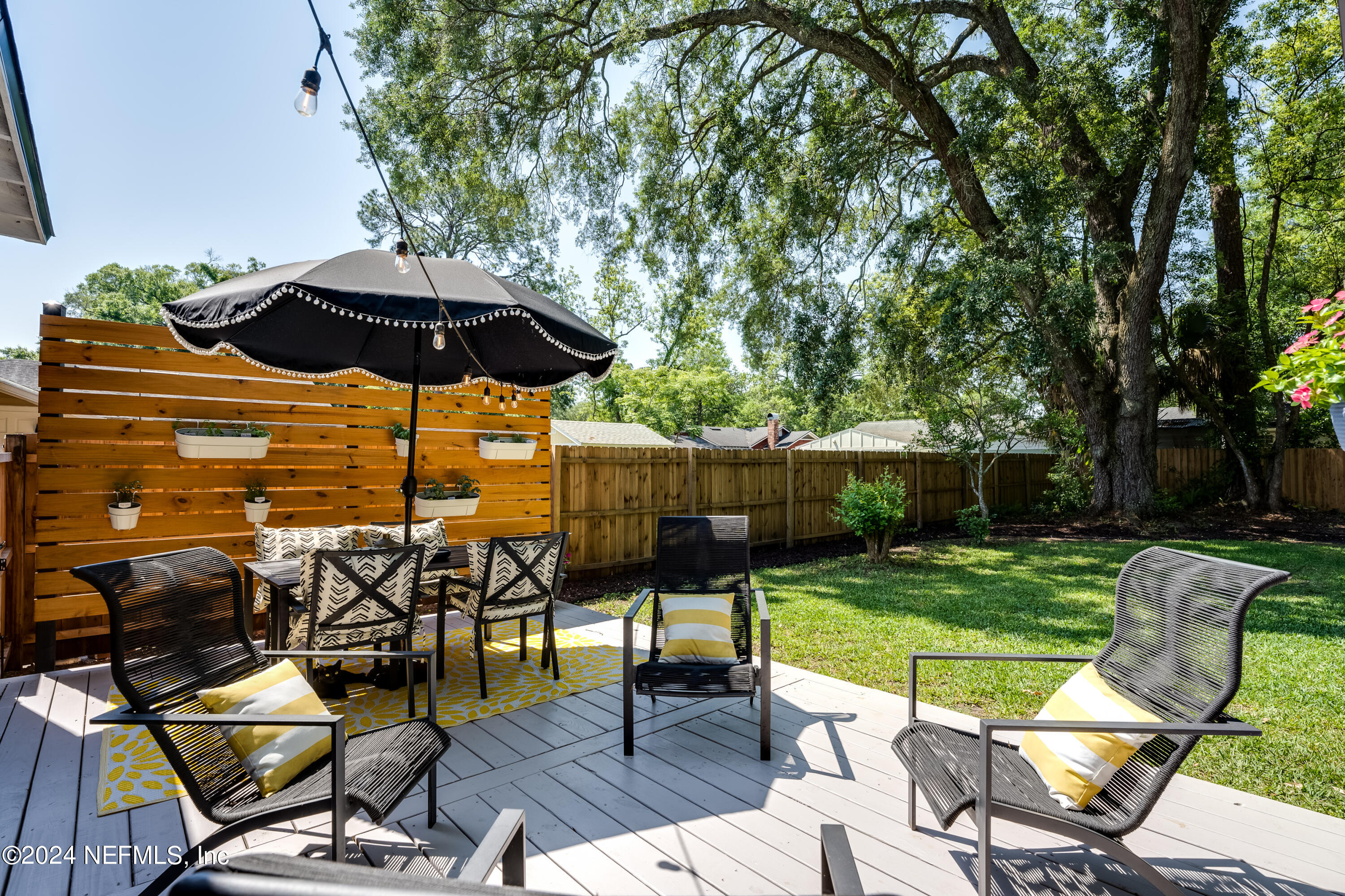1322 Rensselaer Avenue Jacksonville, FL 32205 - Photo 30 of 37 a view of a table and chairs under an umbrella