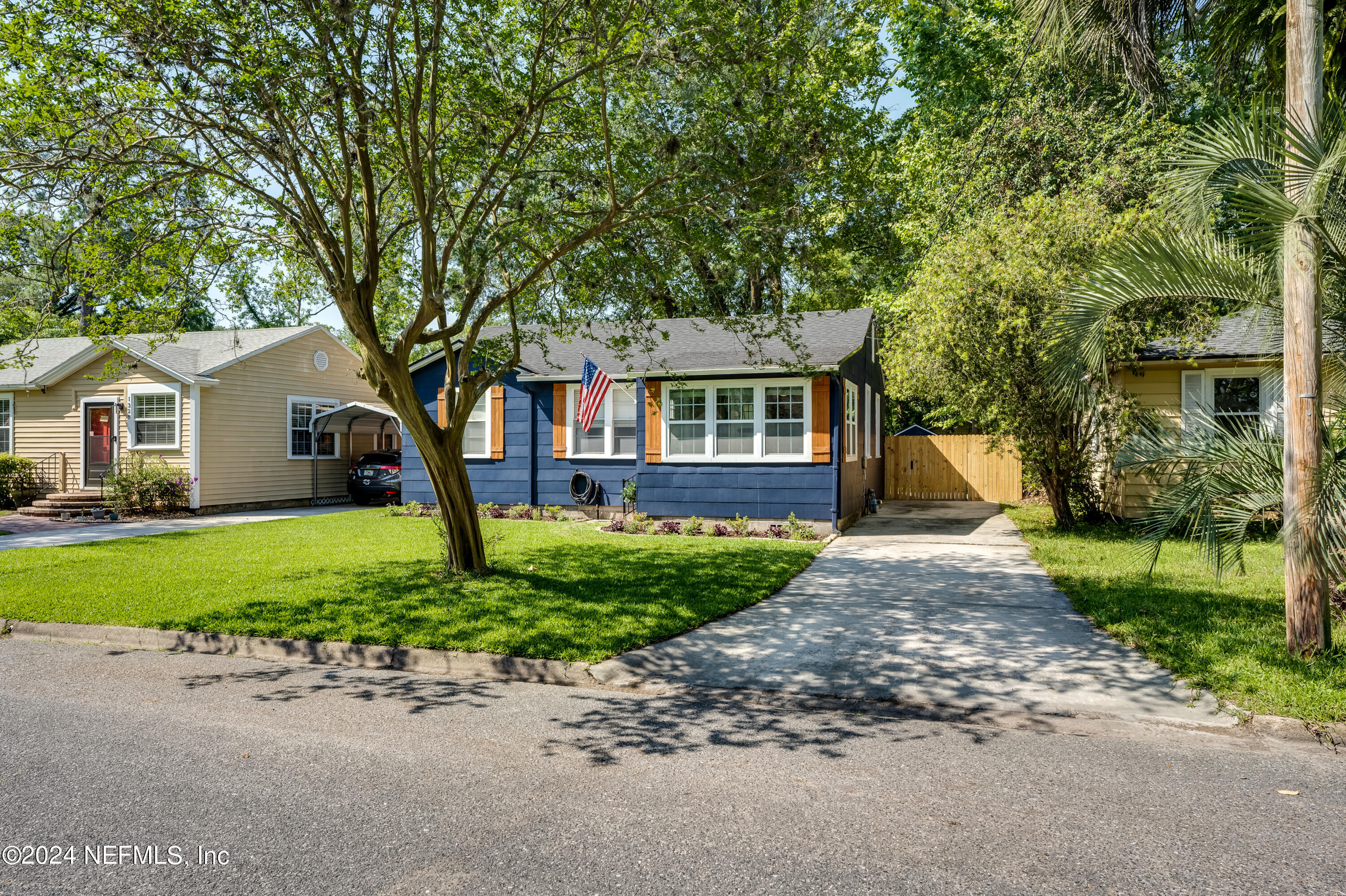 1322 Rensselaer Avenue Jacksonville, FL 32205 - Photo 3 of 37 a front view of a house with a garden and trees