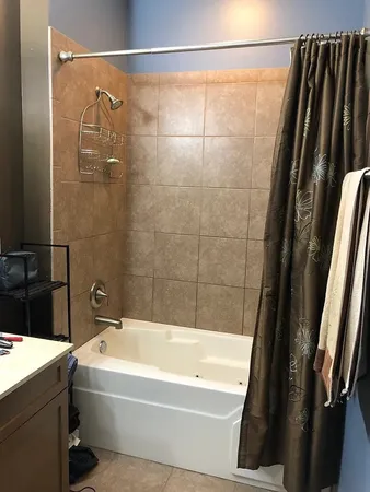 a bathroom with a bathtub and a shower