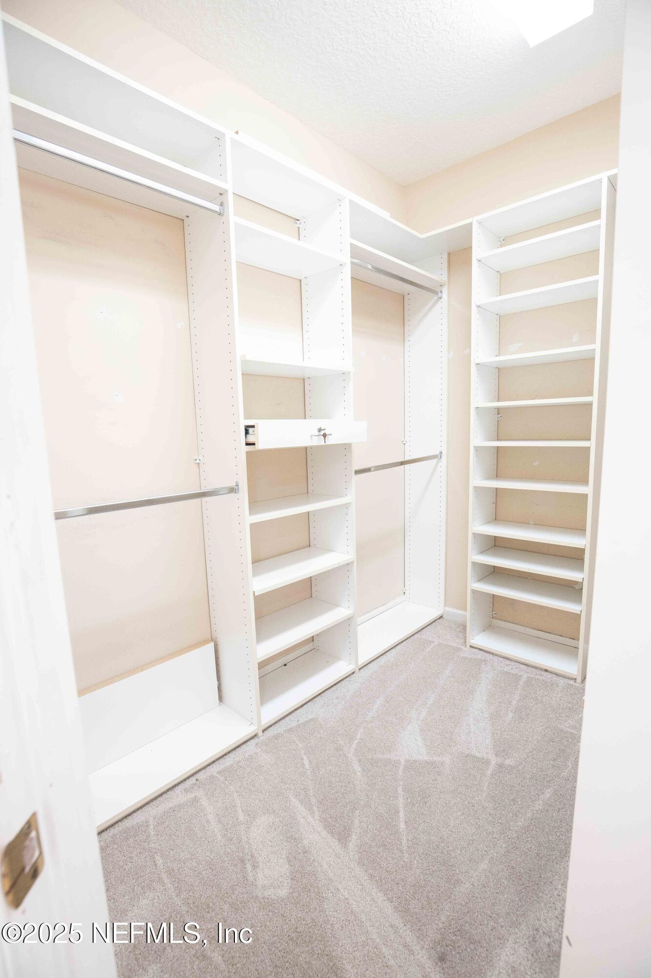 9912 Margate Hills Road Jacksonville, FL 32256 - Photo 11 of 17 a view of walk in closet with empty racks