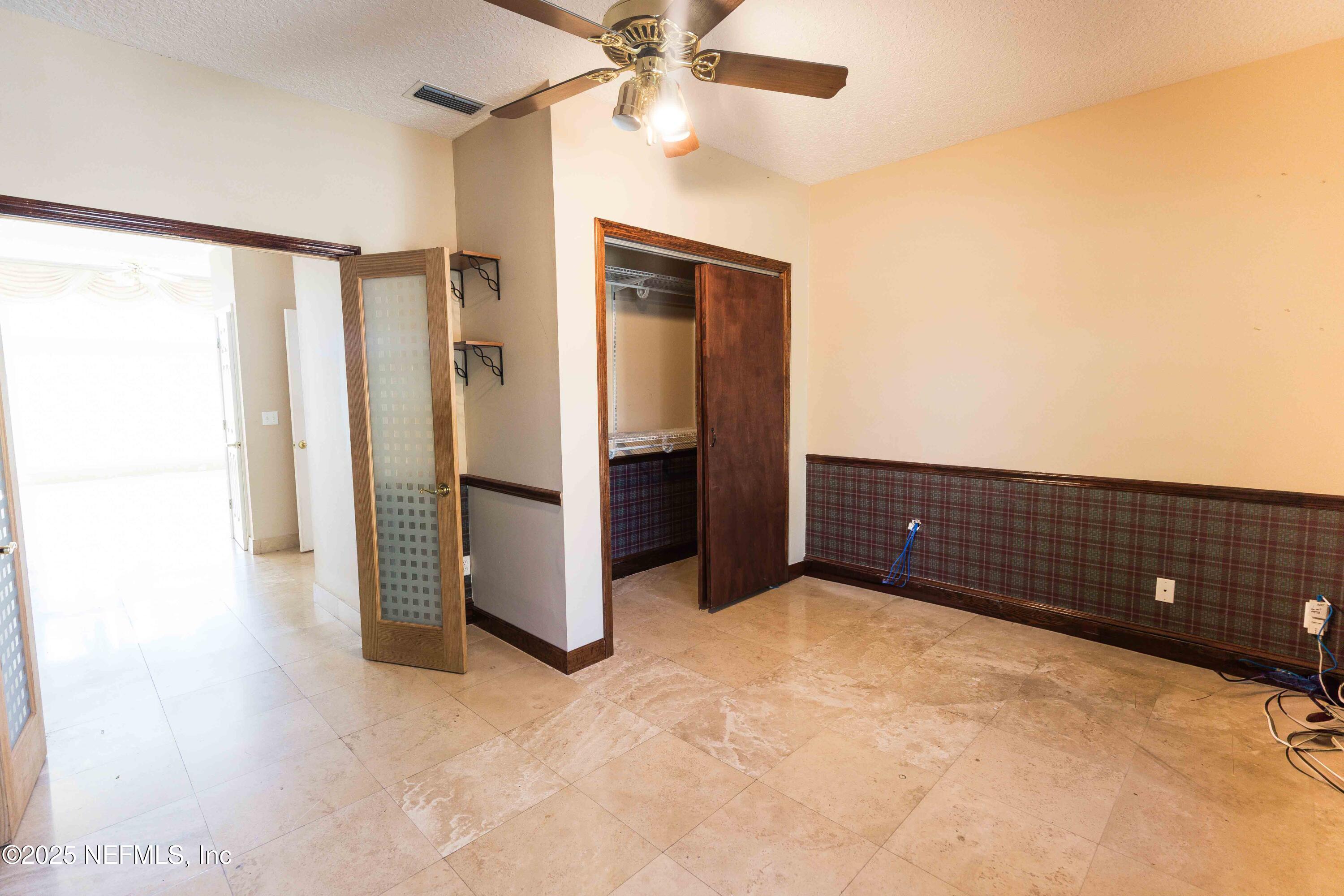 9912 Margate Hills Road Jacksonville, FL 32256 - Photo 14 of 17 a view of an empty room with a ceiling fan