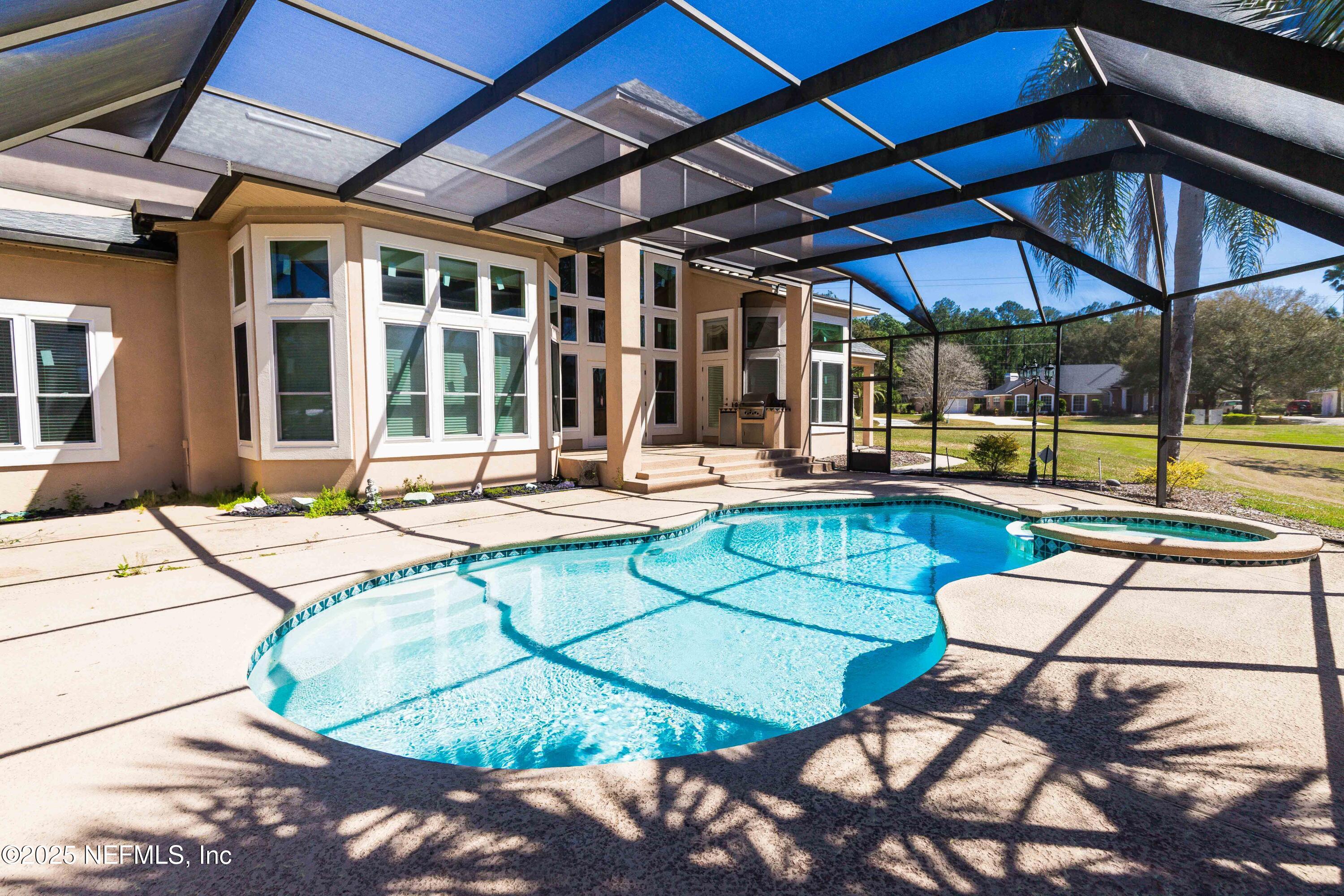 9912 Margate Hills Road Jacksonville, FL 32256 - Photo 17 of 17 a patio with a table and chairs under an umbrella