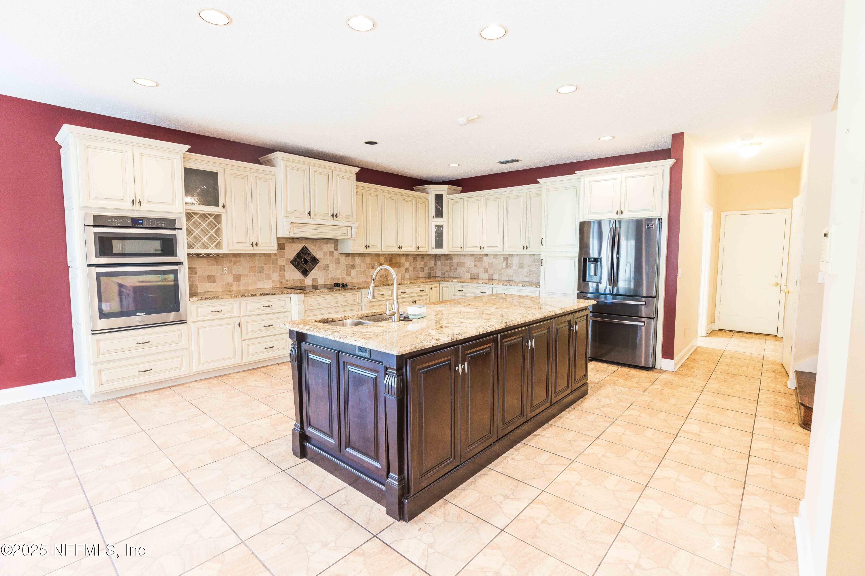 9912 Margate Hills Road Jacksonville, FL 32256 - Photo 6 of 17 a kitchen with stainless steel appliances granite countertop a stove a sink and a refrigerator