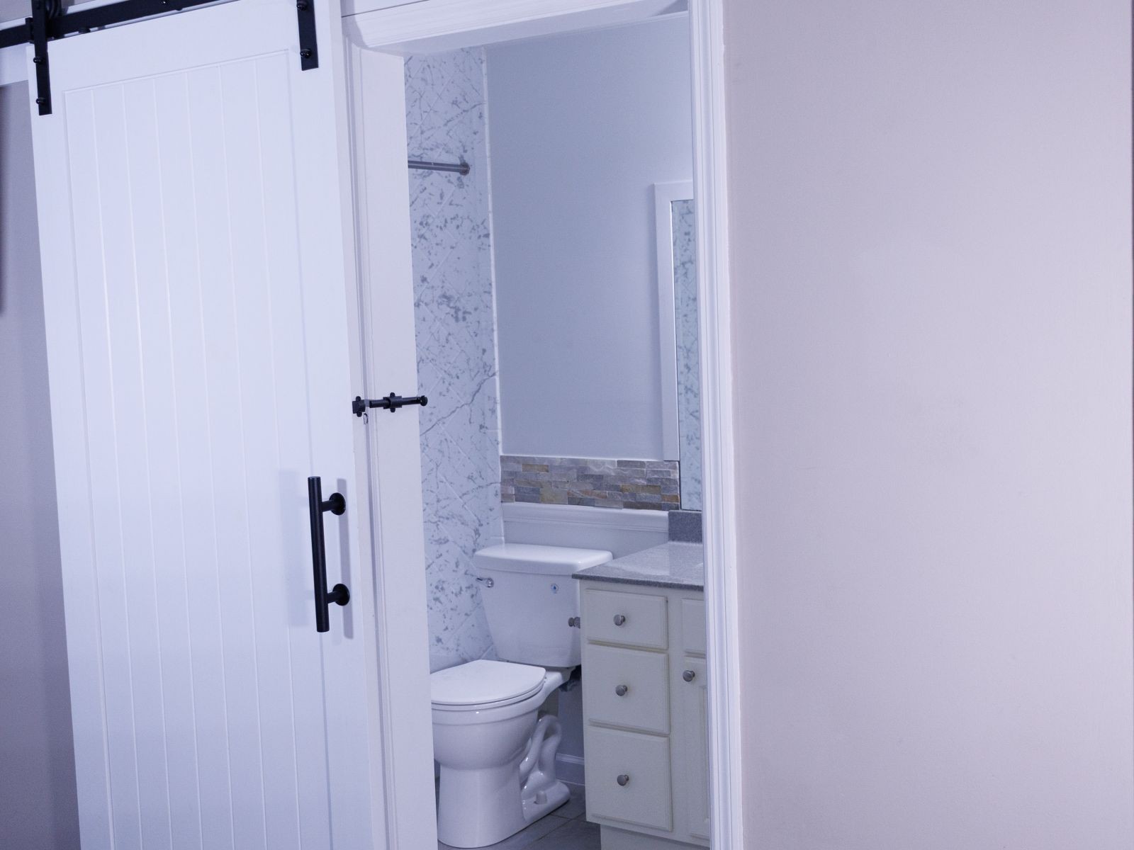 238 Ellington Place Madison, TN 37115 - Photo 8 of 10 a bathroom with a granite countertop toilet a sink and a shower