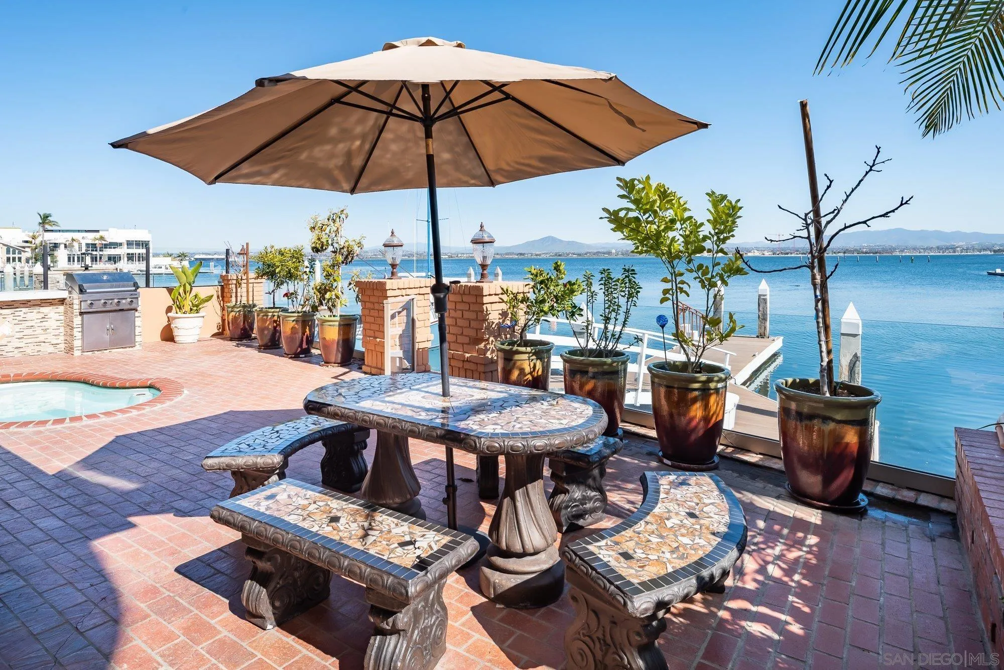 5 Sandpiper Strand Coronado, CA 92118 - Photo 1 of 70 a view of a patio with furniture and table under an umbrella