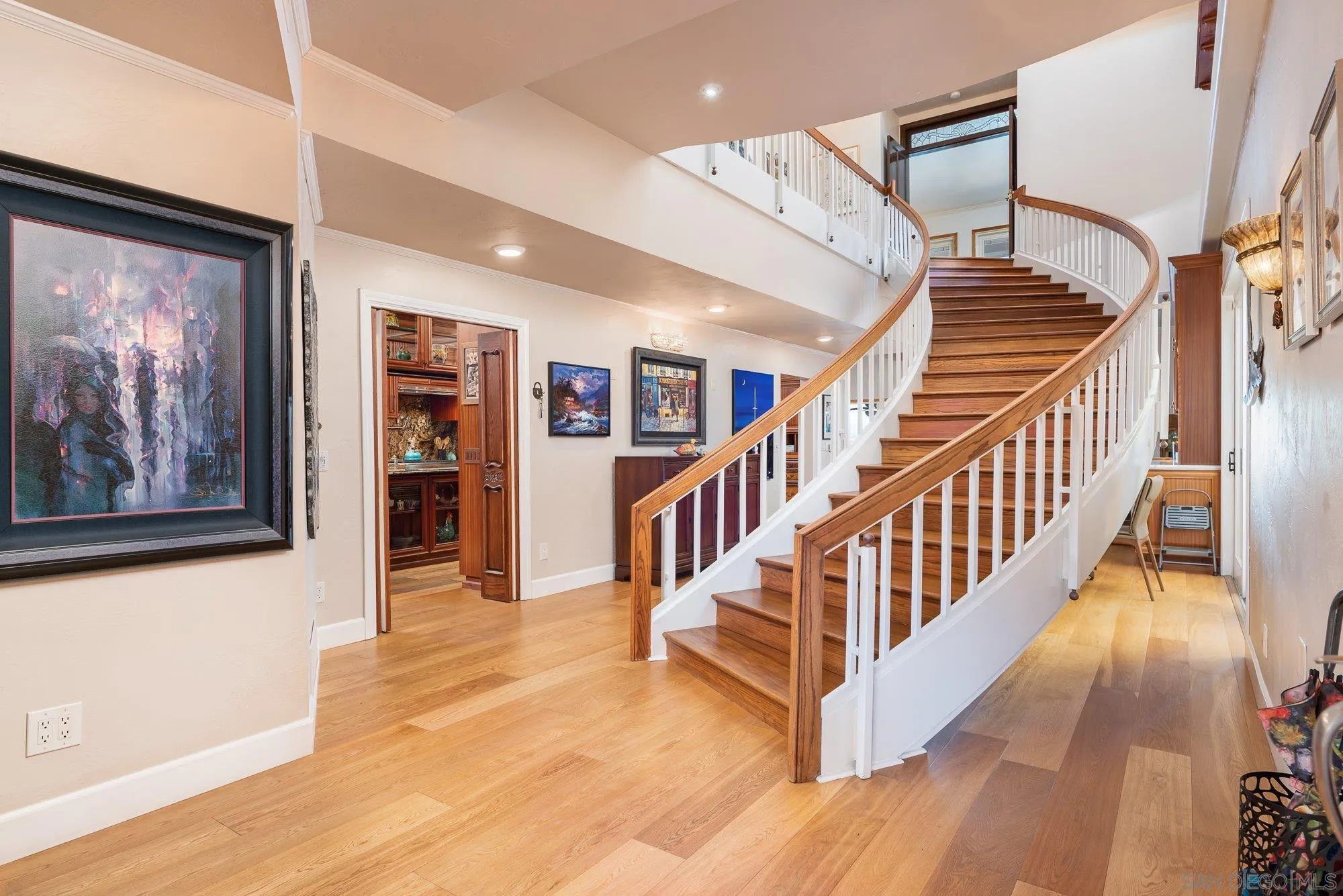 5 Sandpiper Strand Coronado, CA 92118 - Photo 11 of 70 a view of staircase with lots of frames on wall and wooden floor