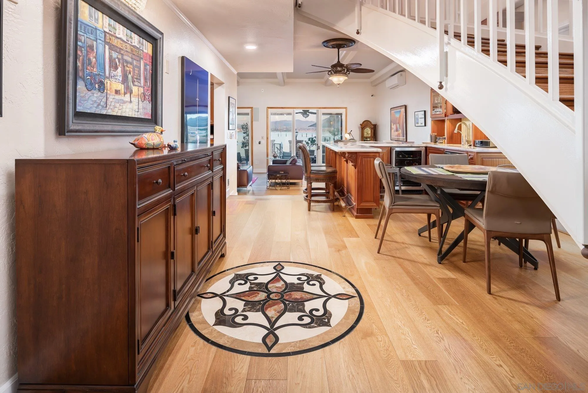 5 Sandpiper Strand Coronado, CA 92118 - Photo 12 of 70 a living room with furniture a wooden floor and a chandelier