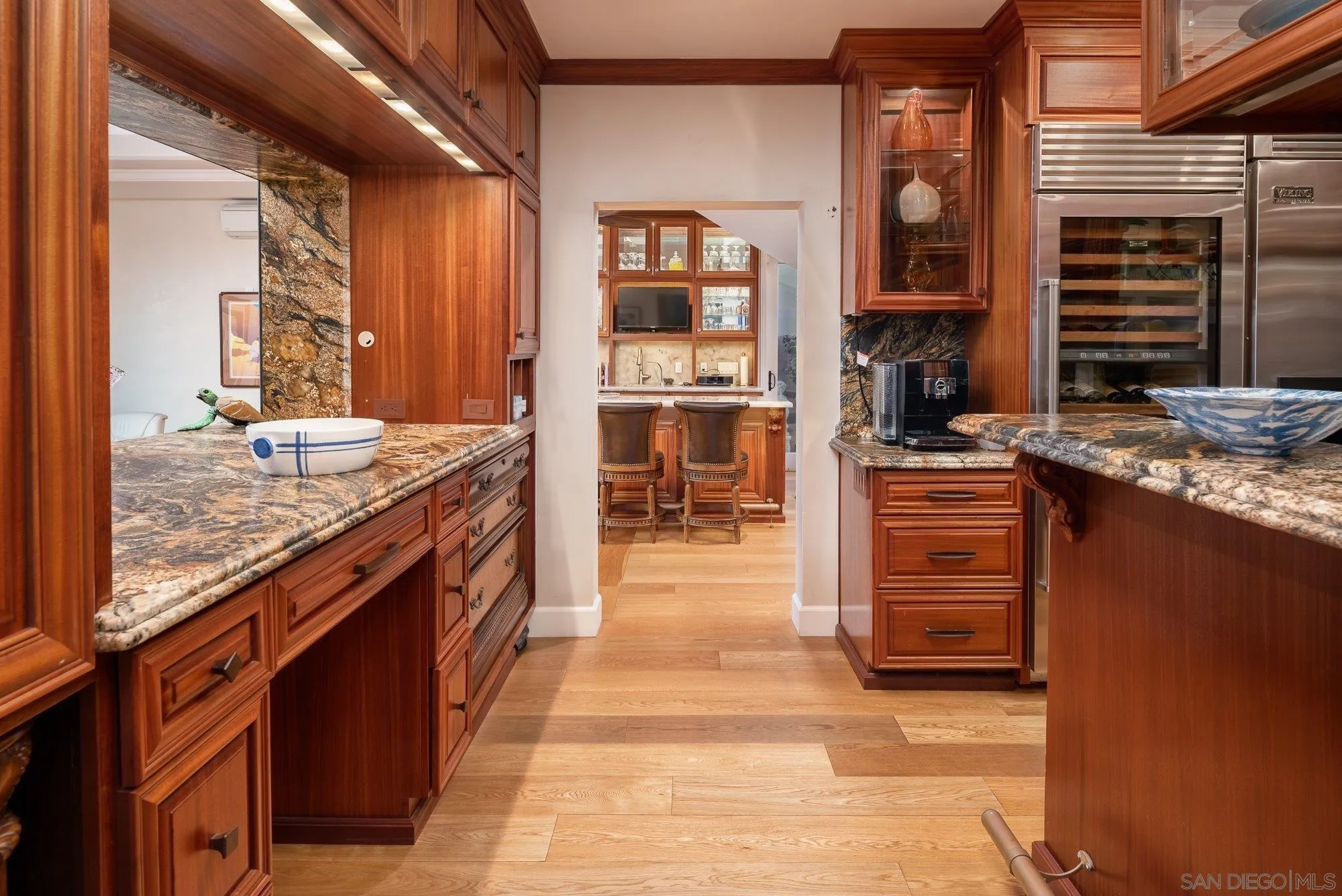 5 Sandpiper Strand Coronado, CA 92118 - Photo 28 of 70 a large kitchen with stainless steel appliances granite countertop a stove and a wooden cabinets