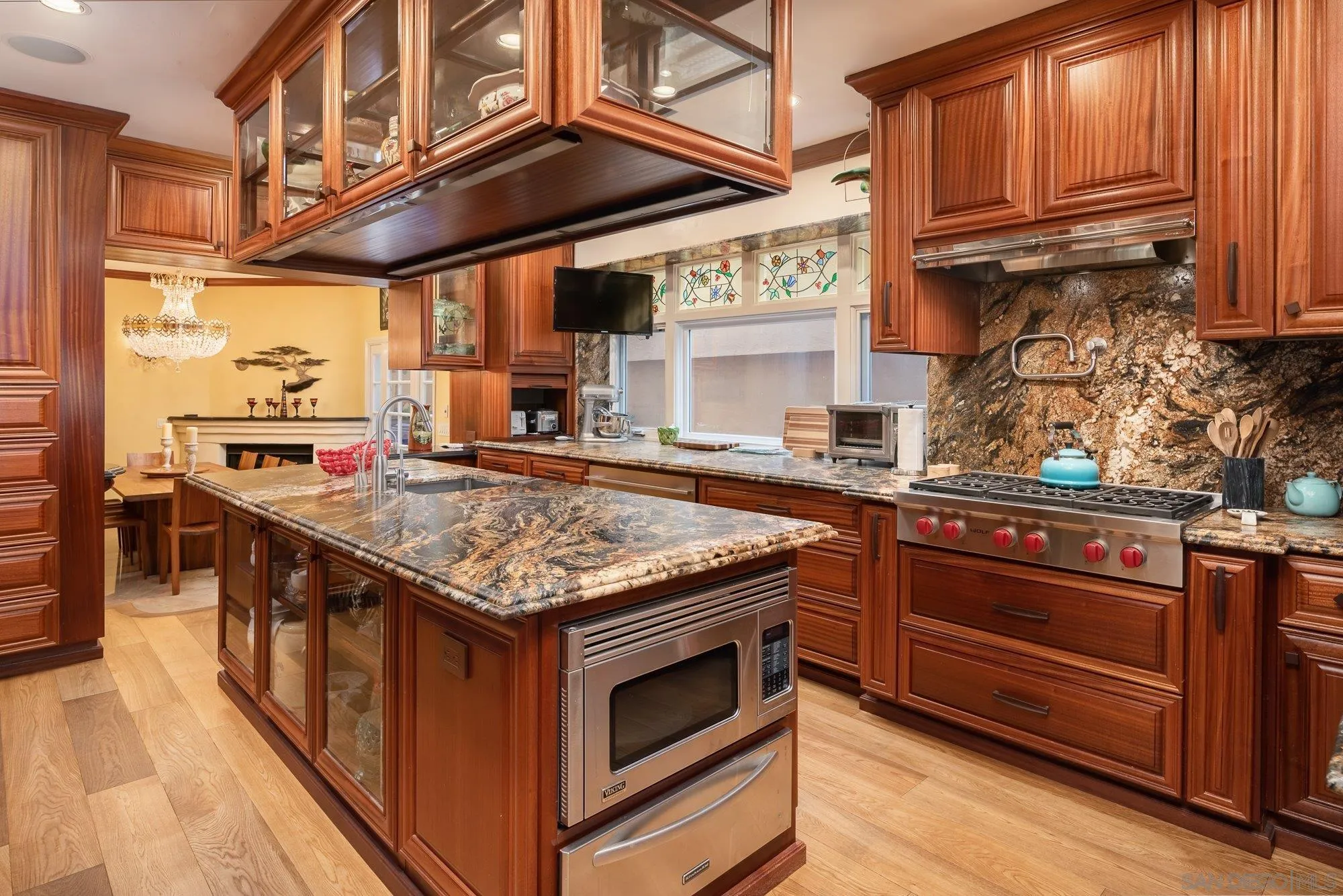 5 Sandpiper Strand Coronado, CA 92118 - Photo 30 of 70 a kitchen with stainless steel appliances granite countertop a stove and a wooden cabinets