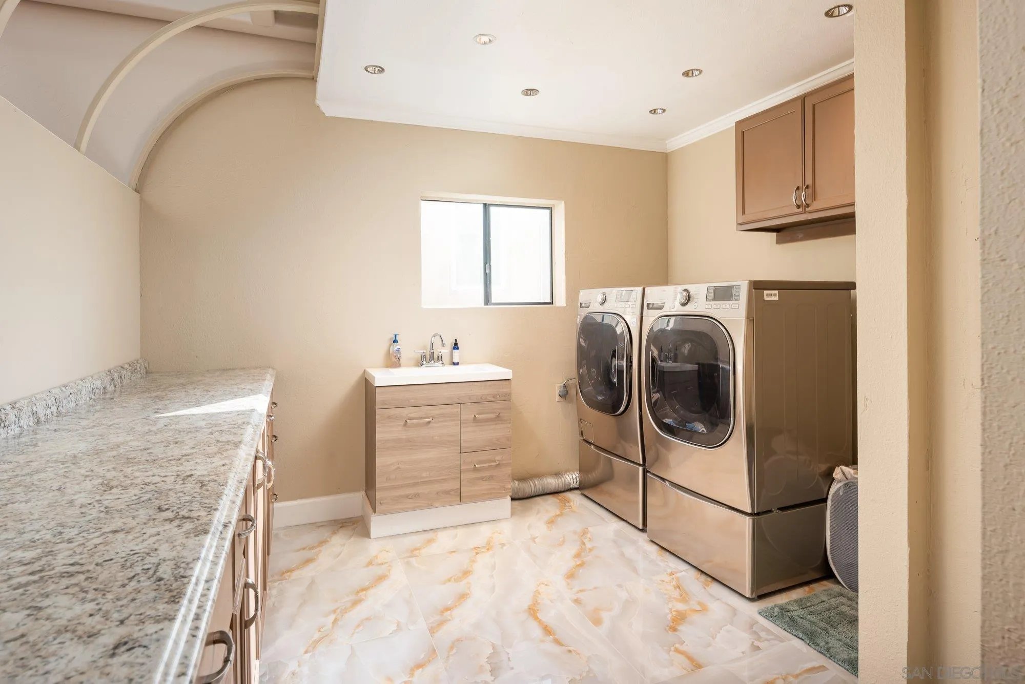 5 Sandpiper Strand Coronado, CA 92118 - Photo 54 of 70 a utility room with cabinets washer and dryer