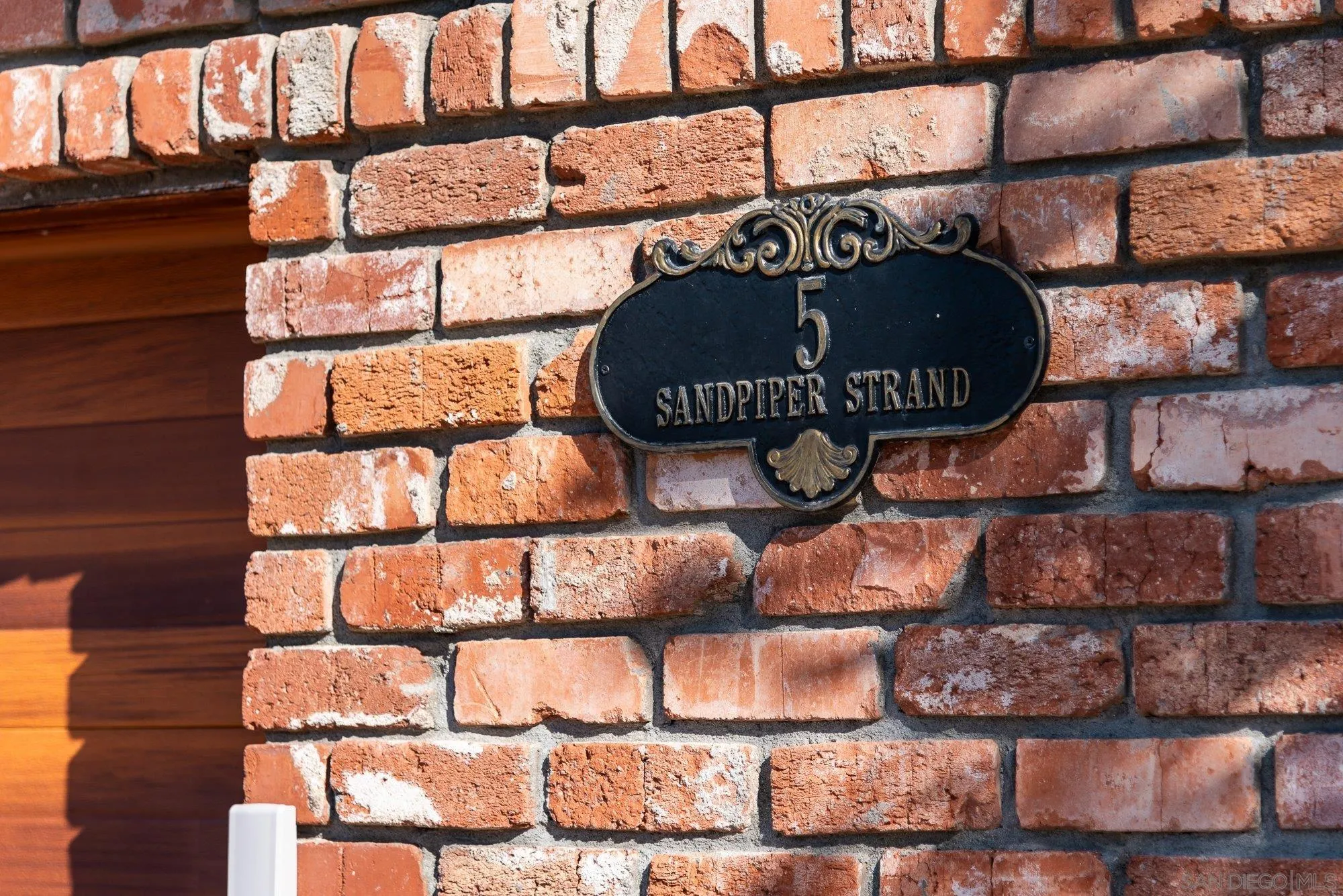 5 Sandpiper Strand Coronado, CA 92118 - Photo 8 of 70 a wooden bench sitting in front of a building