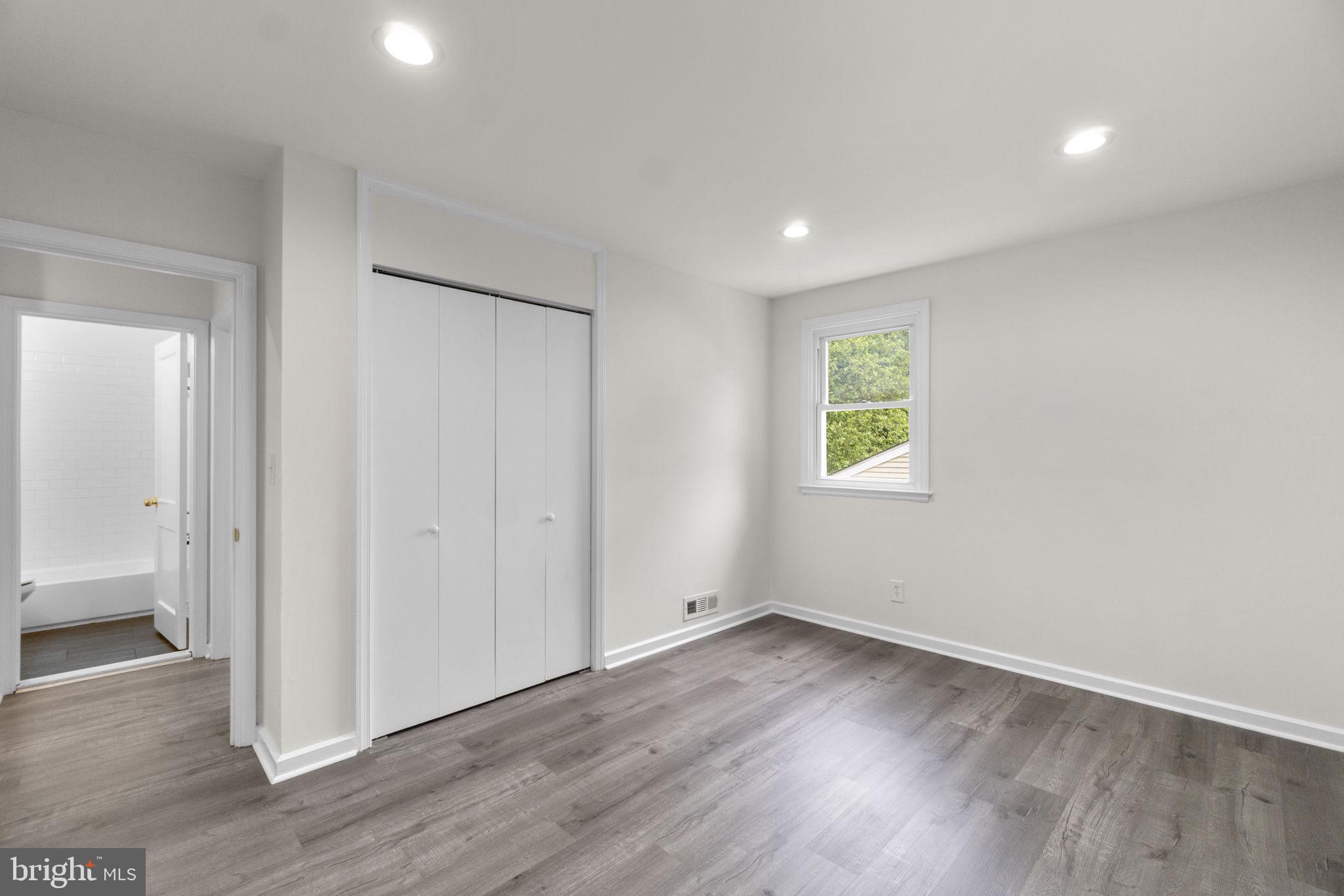 3658 Clifmar Road Baltimore, MD 21244 - Photo 23 of 43 an empty room with wooden floor and windows