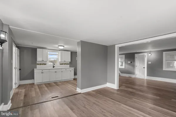 a large white room with kitchen view and living room