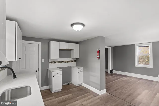 a room with a sink and a mirror