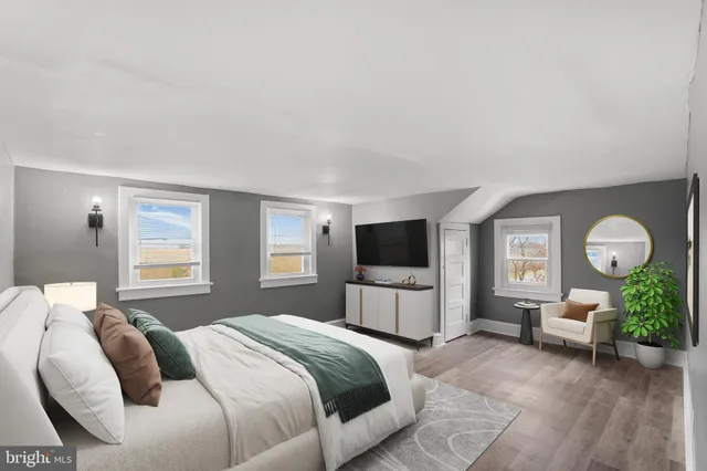 a bedroom with a bed a couch and dresser