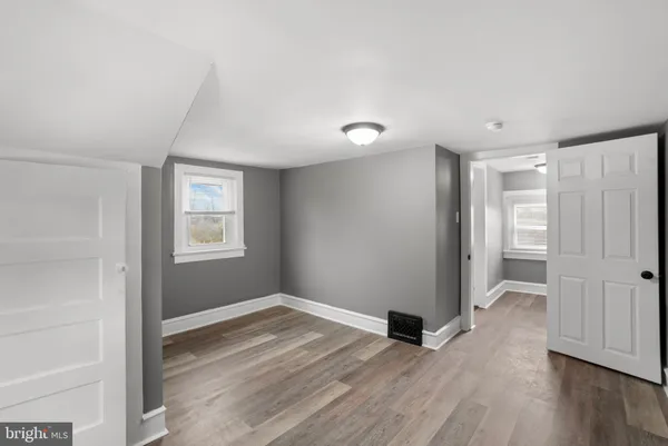 a view of an empty room with wooden floor