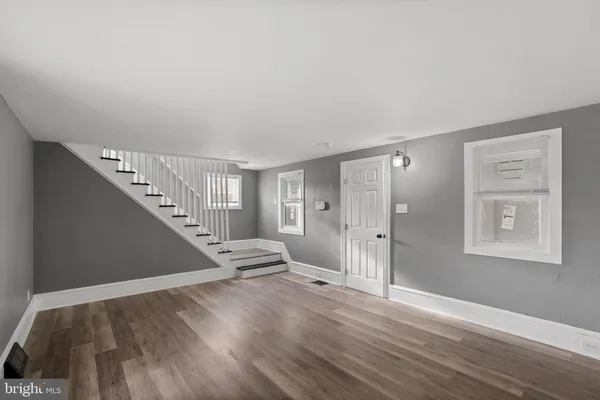 a view of entryway and hall with wooden floor