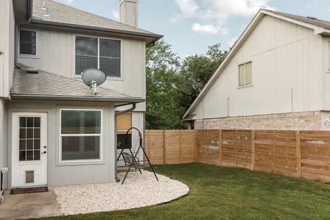 a backyard of a house with lots of green space and garden