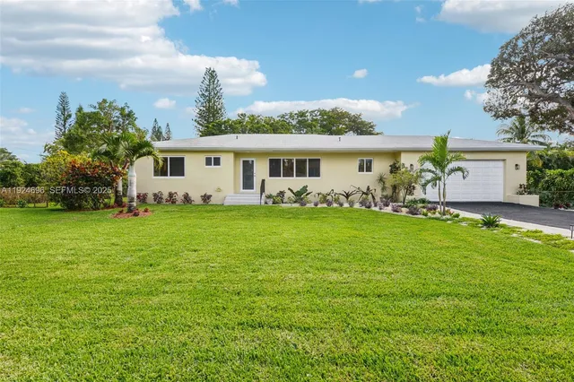 a front view of house with yard and green space