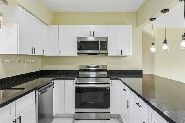 a kitchen with granite countertop a stove and a sink