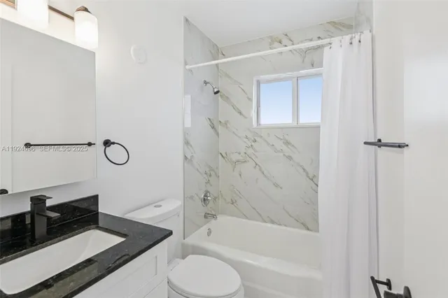 a bathroom with a shower a mirror and a sink