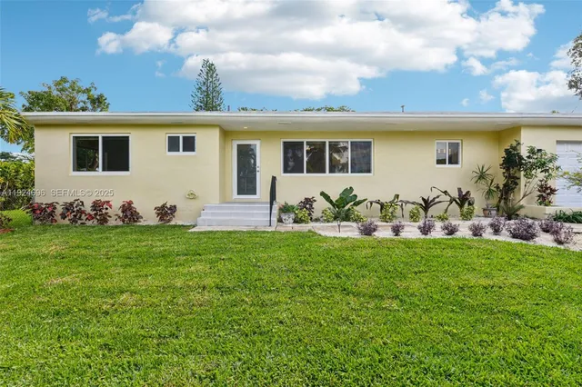 a front view of house with yard and outdoor seating