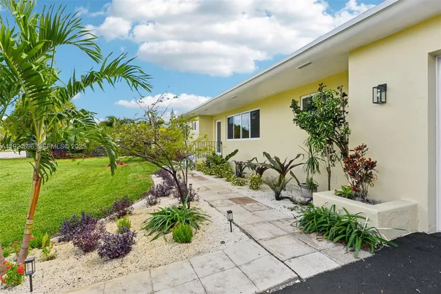 a front view of a house with garden