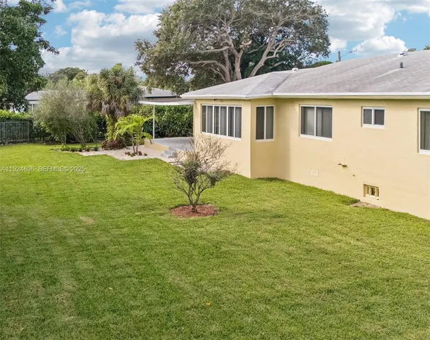 an aerial view of residential houses with outdoor space and river