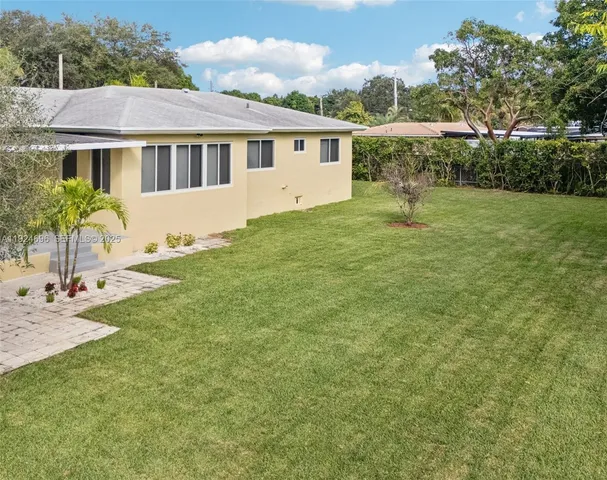an aerial view of a house with a yard