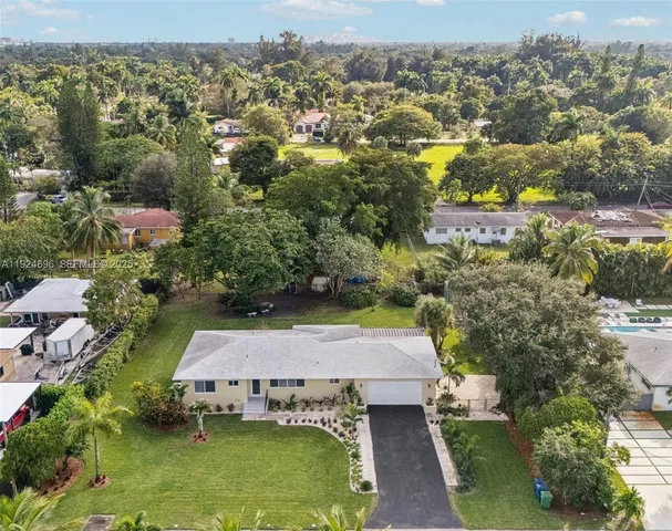 an aerial view of a residential houses with outdoor space