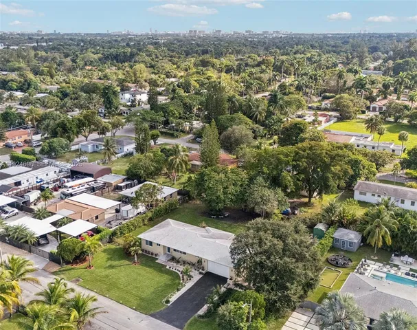 an aerial view of residential houses with outdoor space